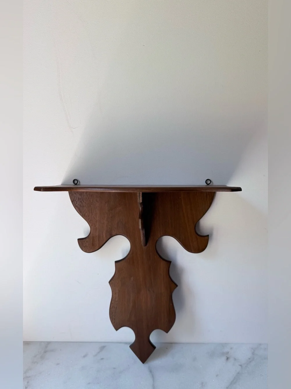 vintage wall sconce shelf made of carved wood with a dark finish
